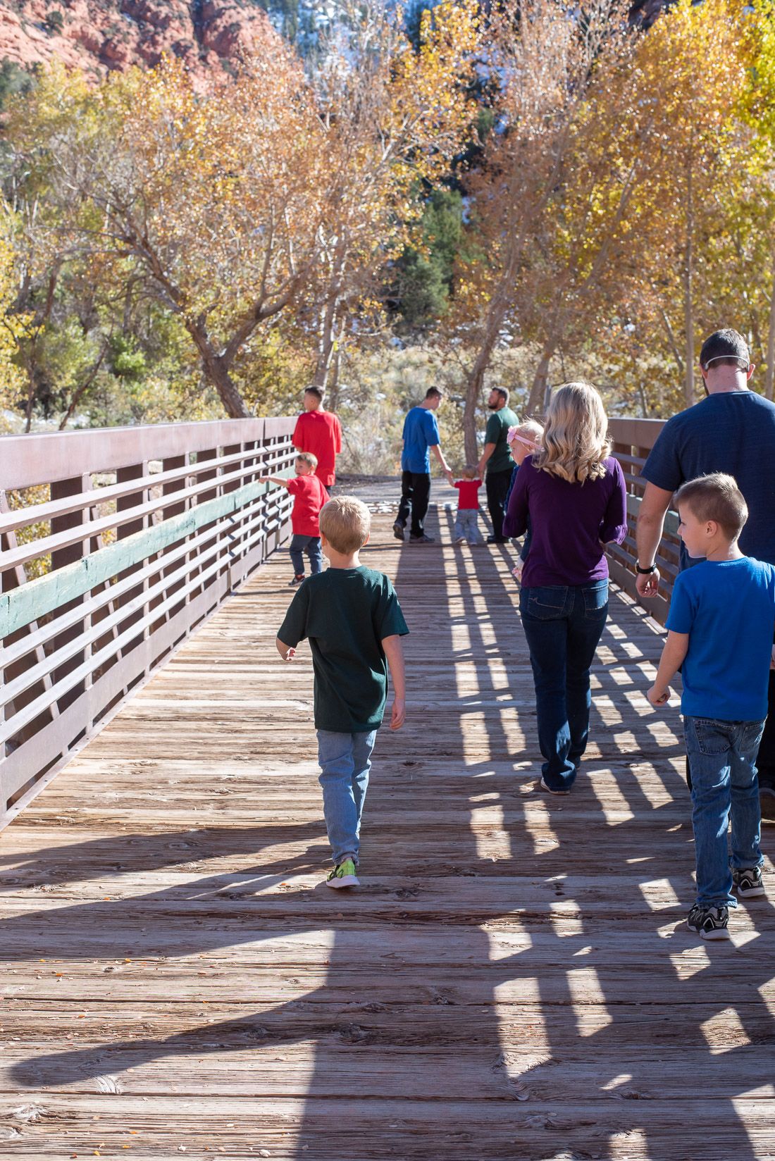 Large family walking across a bridge in Cedar City, Utah-Bethany Allen, family photographer