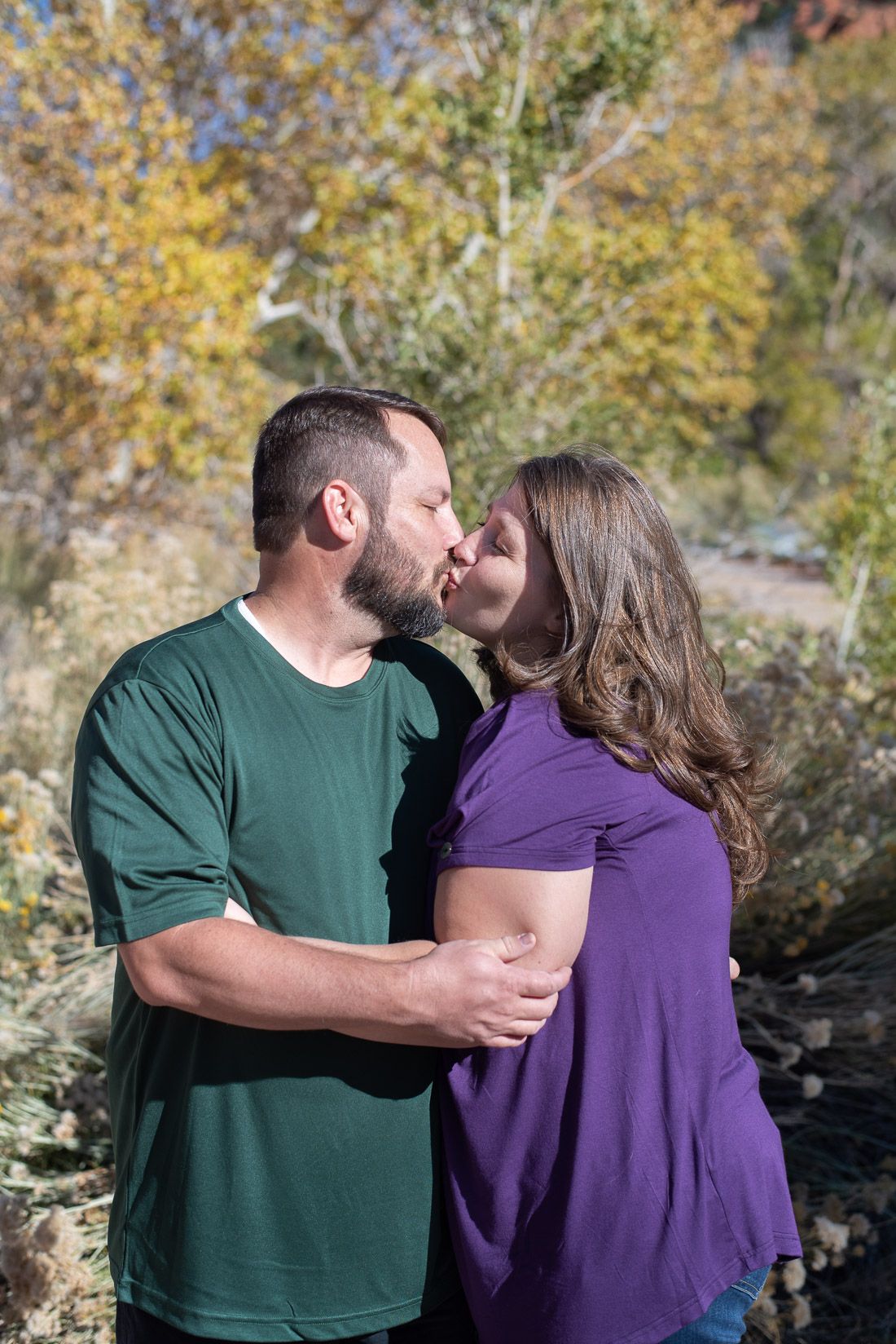 Mom and dad kissing in front of the Cedar City fall leaves-Bethany Allen Photography