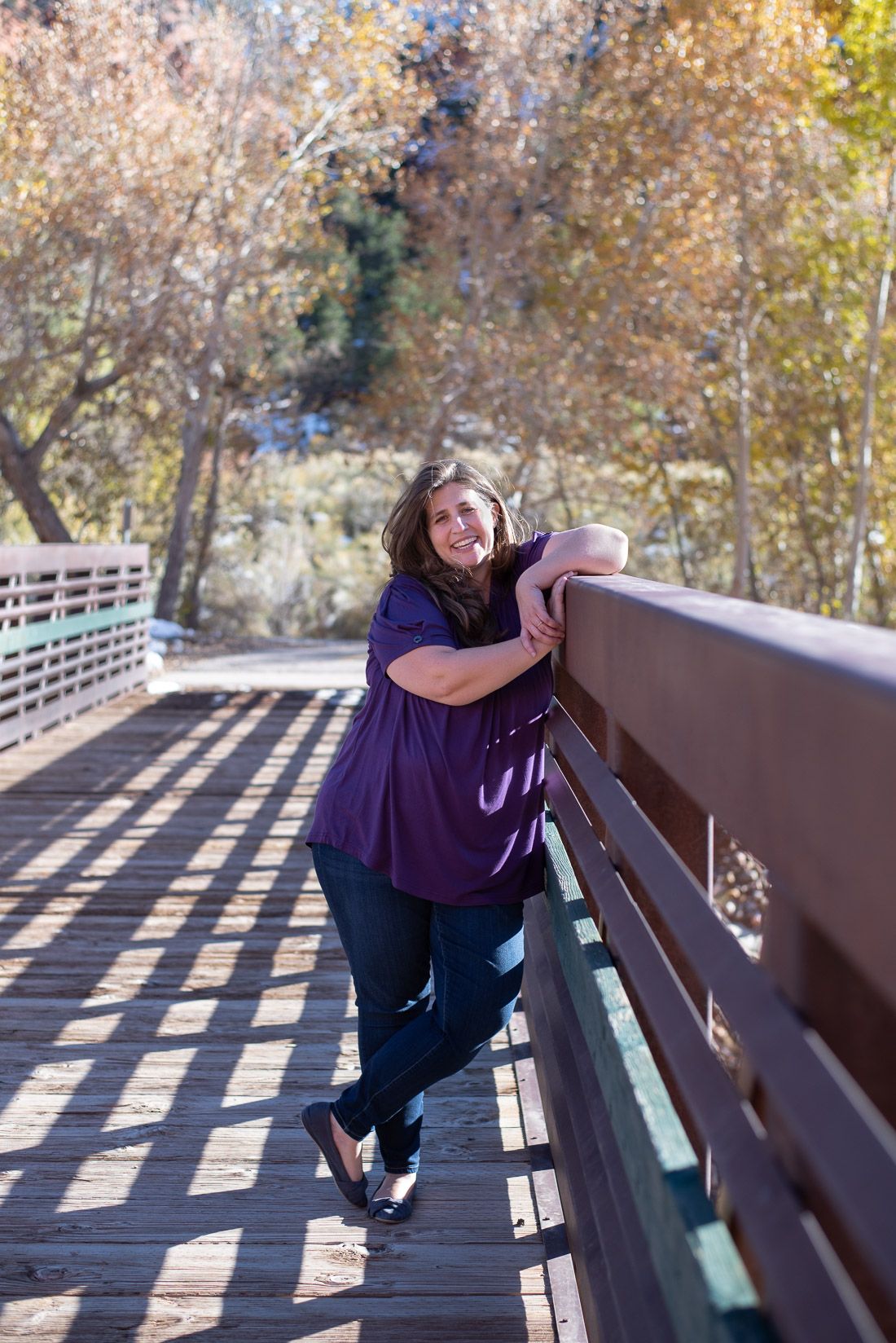 Woman leaning on the railing of the Cedar canyon bridge-Bethany Allen Photography