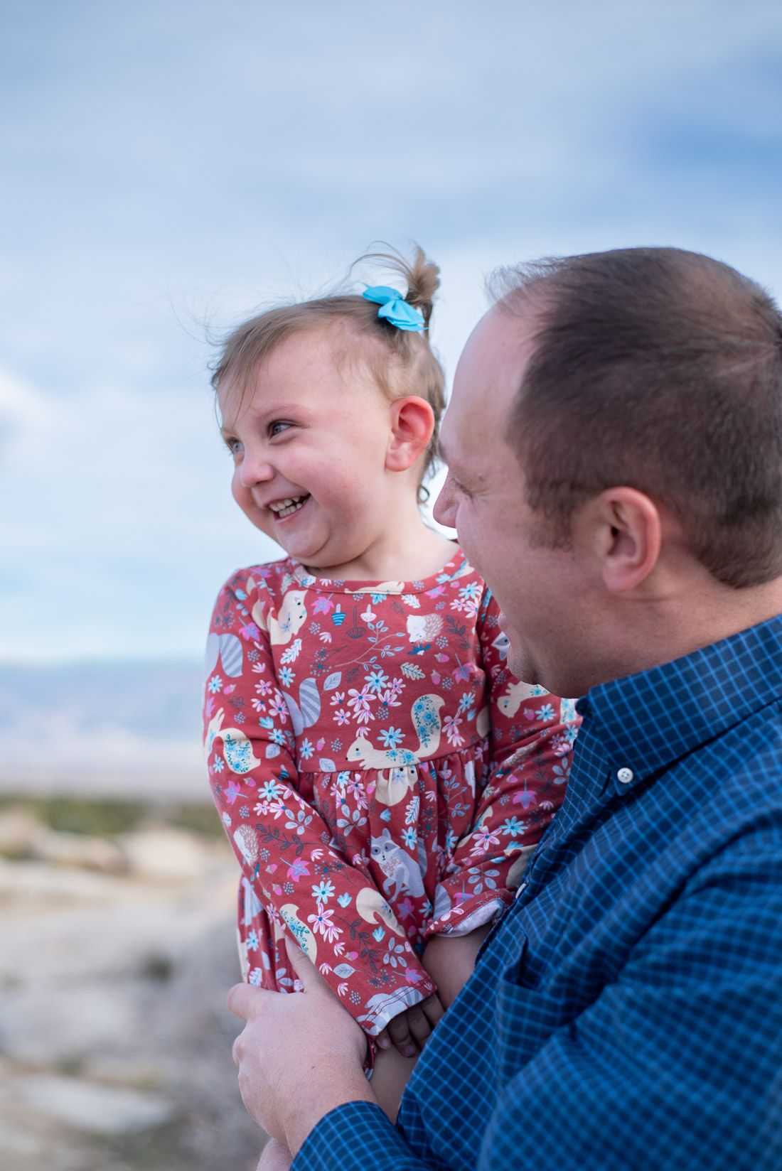 Cedar City, Utah dad holding daughter while she is smiling-Bethany Allen Photography