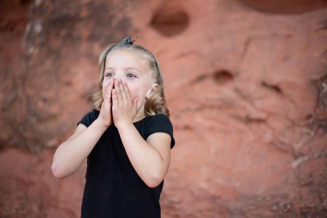 Girl covering her mouth with her hands in surprise