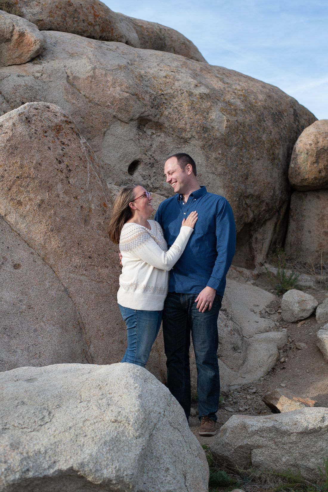 Husband and wife looking at each other while standing in front of rocks-Bethany Allen Photograp