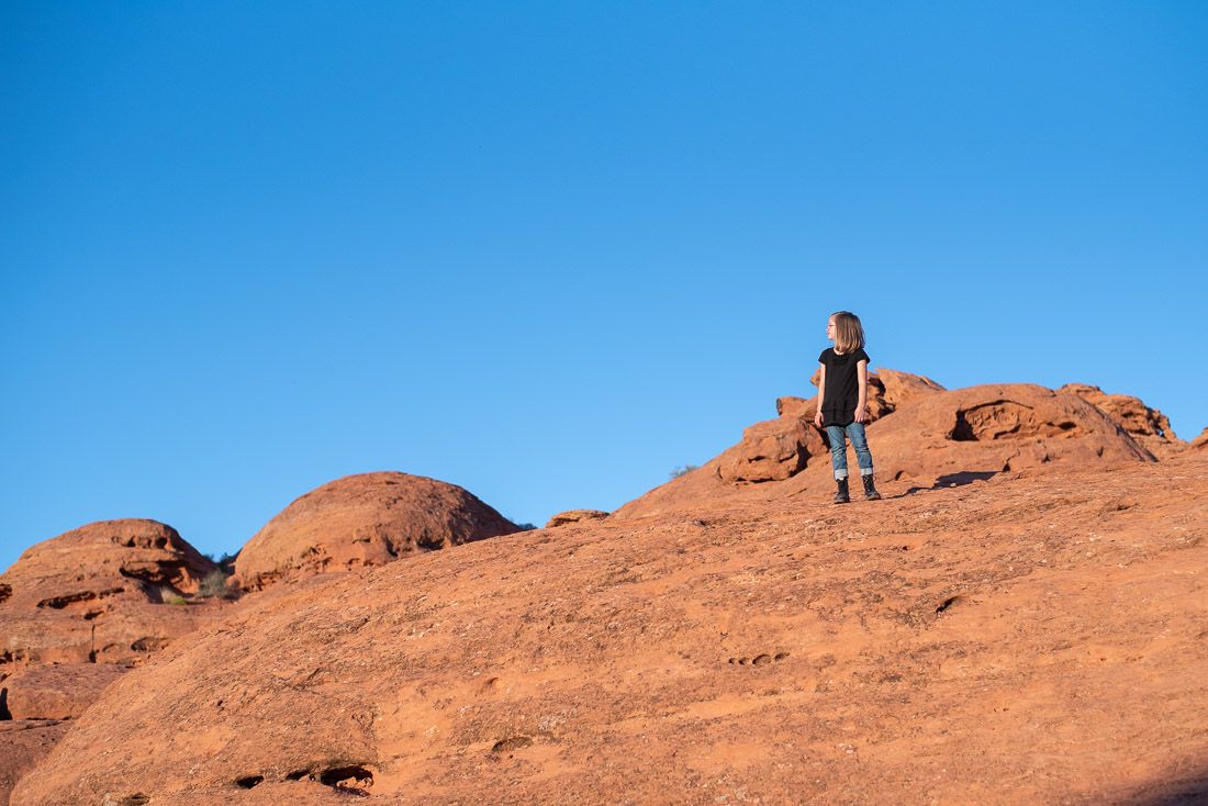 Young girl standing on top of red rocks-St. George, Utah