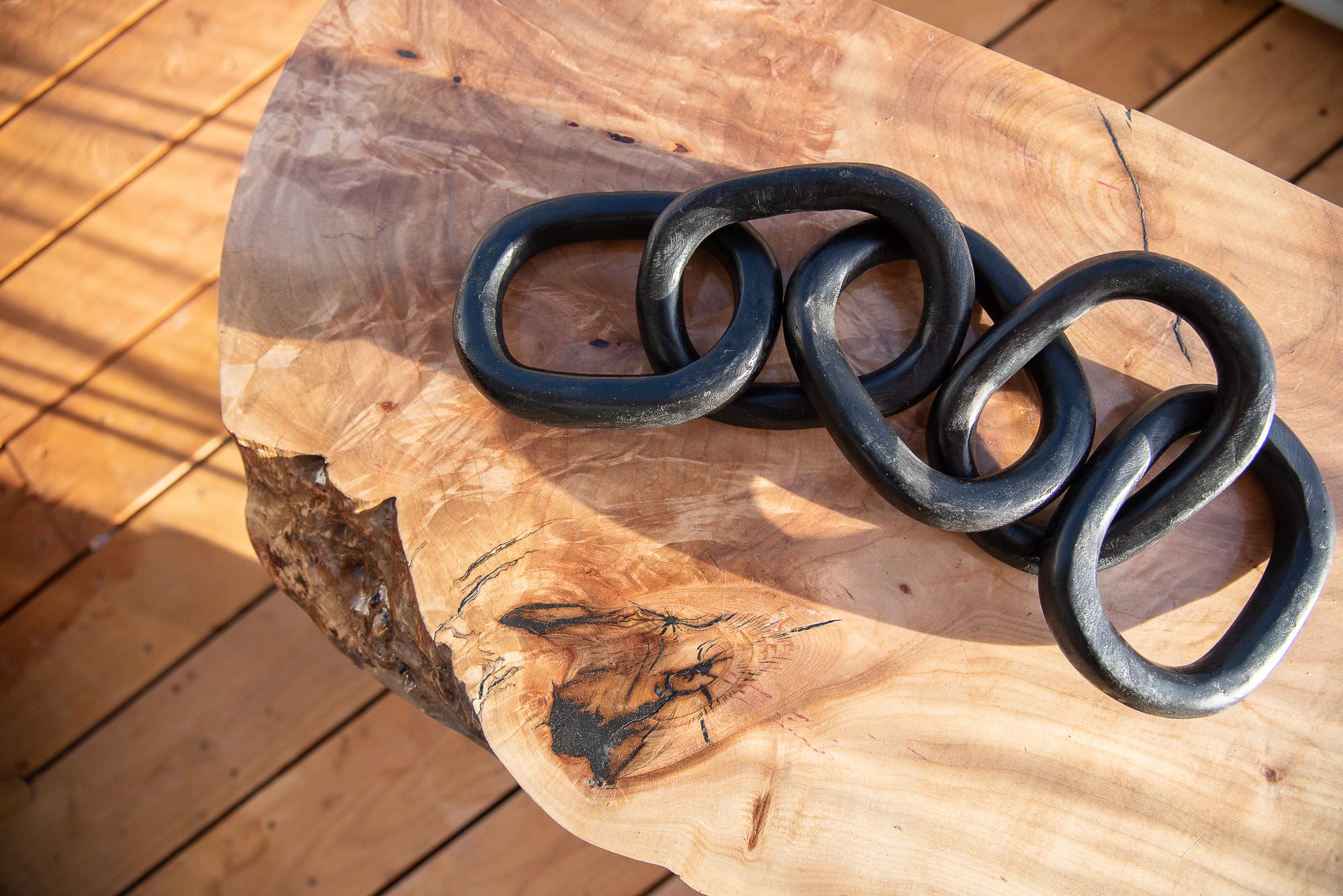 A closeup of a decorative chain on a wooden table